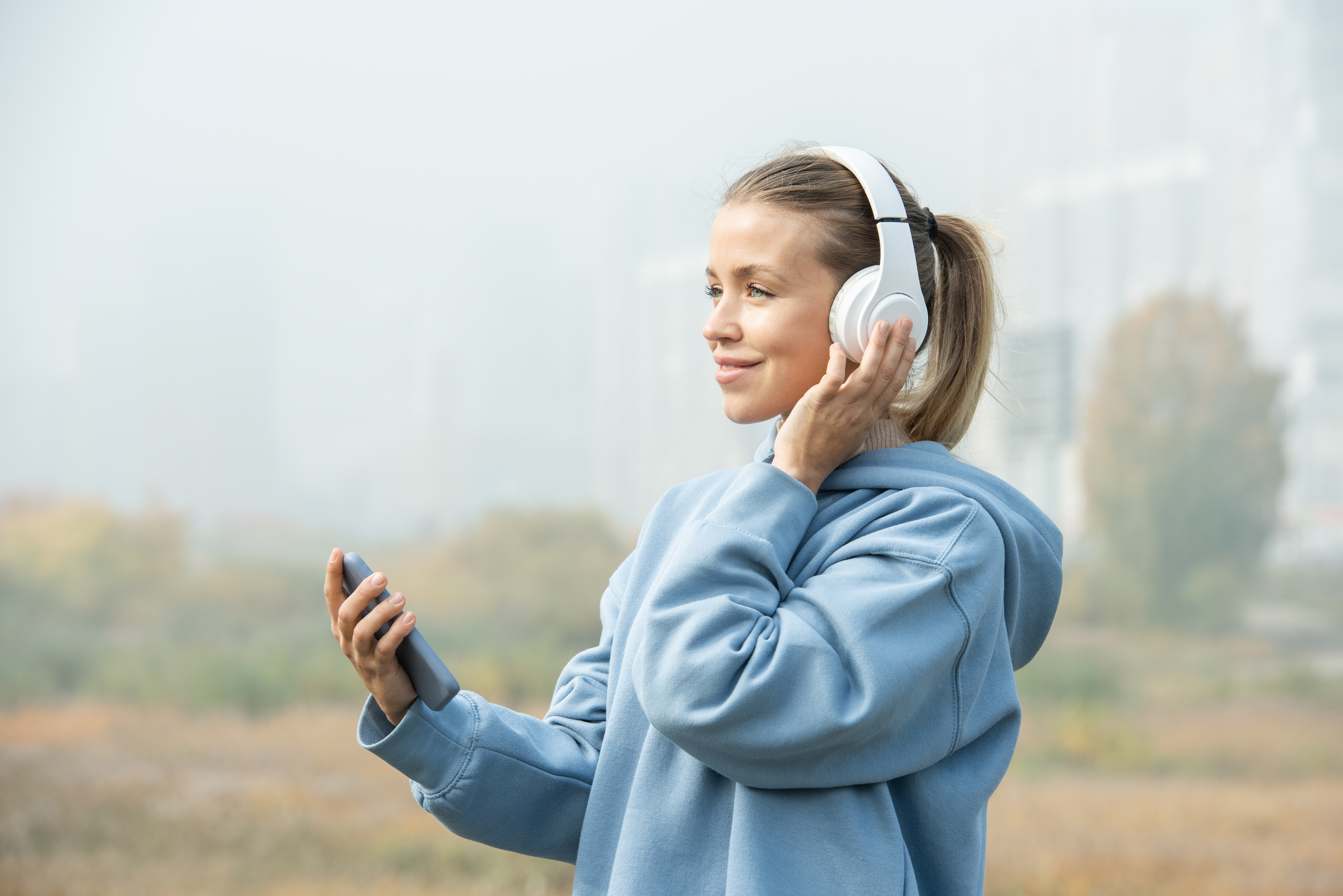 Lady with phone and headphones